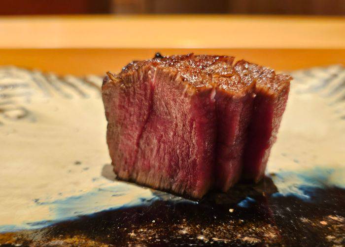 Three slices of wagyu beef chateaubriand, seared to perfection and still pink in the middle.